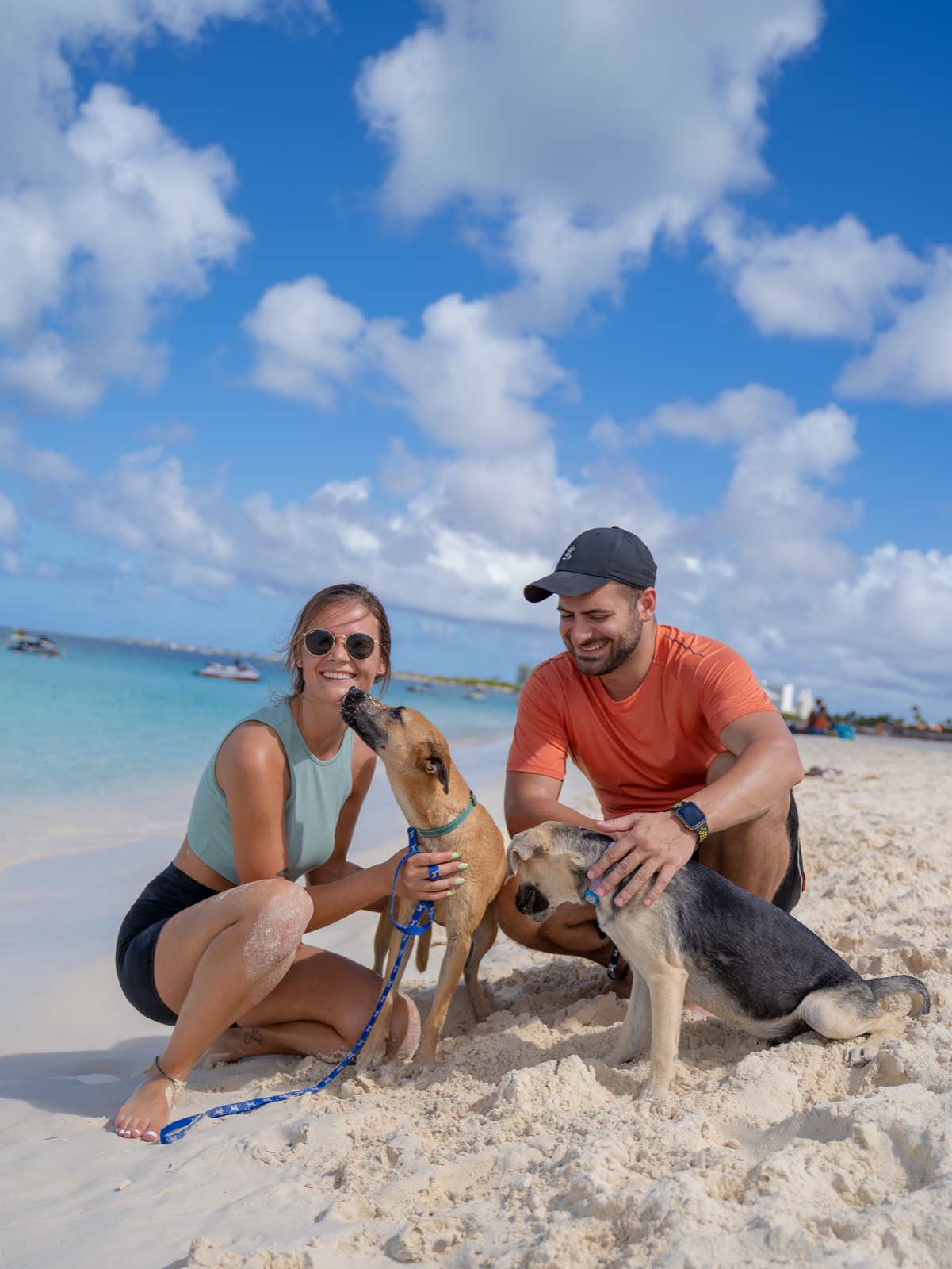 Hope and Levon with rescued dogs on the beach